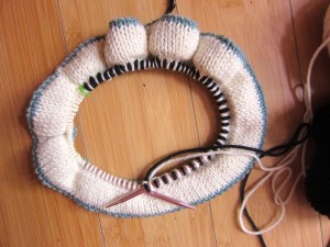 The first round in creating a braid is knit, alternating stitches in main color and contrasting color(s).